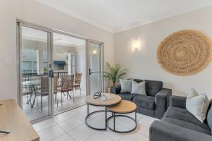 a living room with a couch and a table at Whitfield Waters - Resort Living for Families in Edge Hill