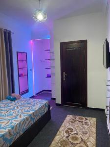 a bedroom with a bed and a purple light at horus desert hotel in Cairo