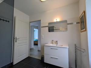 a white bathroom with a sink and a mirror at Fermette rénovée à Argy - Proche forêt et châteaux, jardin, équipement bébé, animaux acceptés - FR-1-591-253 in Argy +14 photos