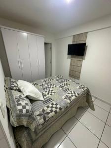 a bedroom with a bed in a room at Apartamento ao lado patio forro in Caruaru +7 photos