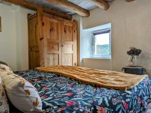 1 dormitorio con 1 cama grande y cabecero de madera en Gîte Saint-Préjet-d'Allier, 4 pièces, 6 personnes - FR-1-582-44 en Saint-Préjet-dʼAllier