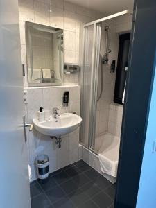 a bathroom with a sink and a shower at Friesdorfer Hof in Bonn