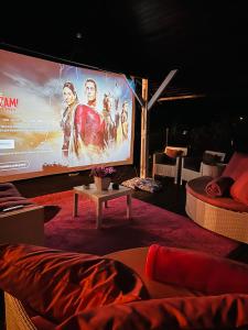 a large screen with a movie projected on it at Pousada Pink Village in Campos do Jordão