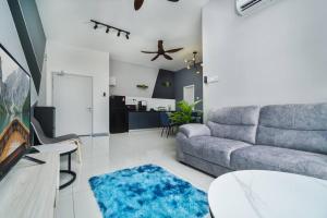 a living room with a couch and a table at Ben Cozy Executive Suite 3BR The Horizon Ipoh in Ipoh