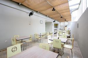 an empty room with tables and chairs in it at Zodiak Asia Afrika by KAGUM Hotels in Bandung
