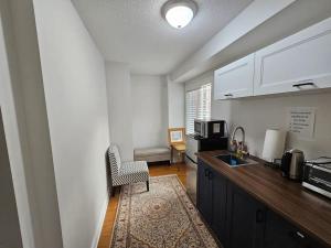 a kitchen with a sink and a counter top at One Bedroom Apartment in Ajax