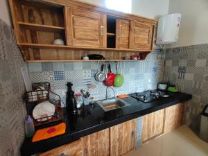 a kitchen with a sink and a counter top at Molog guest house in Ubud +21 photos
