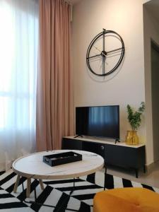 a living room with a large clock on the wall at Amber Cove - Luxury Design By Luxpro Management - 6~7 pax in Malacca