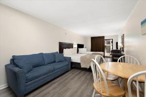 a living room with a couch and a bed and a table at Eden Roc Ocean Side in Ocean City