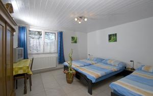 A bed or beds in a room at Hôtel-Gîte rural à 3 km de Delémont