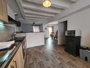 a kitchen with a counter top and a kitchen with a stove at Gîte Verneuil-sur-Igneraie, 3 pièces, 5 personnes - FR-1-591-368 