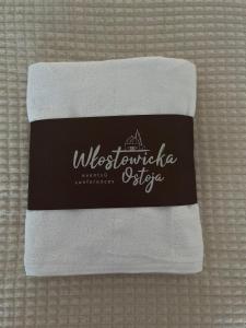 a towel with the name of a hotel on it at Włostowicka Ostoja Apartament in Puławy