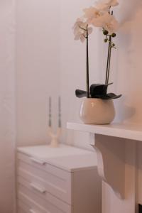 a white vase with flowers in it on a counter at Unionelle a Luxe Newtown Terrance in Sydney