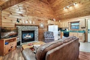 a living room with a couch and a fireplace at Dreamside Peak in Pigeon Forge
