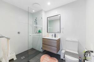 a bathroom with a toilet and a sink and a mirror at Vivid Condo 1B1B in Bankstown in Bankstown +36 photos
