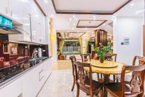 a kitchen and dining room with a table and chairs at Villa FLC Sầm Sơn - Sao Biển 101 in Sầm Sơn