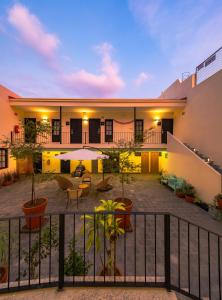 a courtyard of a house with plants and tables at Palpatio Hotel in Guadalajara