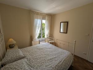 a bedroom with a bed and a window at Gîte Donnery, 4 pièces, 6 personnes - FR-1-590-367 in Donnery