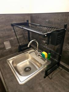 a sink in a bathroom with a shelf above it at Depas MiniLoft in Guadalajara