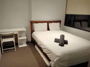 a bedroom with a bed with a pillow and a tv at L39 1Min to SouthernCross,free Gym, Pool, sunna,Tram ,Sauna in Melbourne