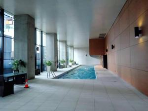 a hallway with a swimming pool in a building at L39 1Min to SouthernCross,free Gym, Pool, sunna,Tram ,Sauna in Melbourne