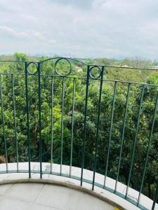 a balcony with a view of a bush at Chateau Elysee A22 near bar resto mall Airport in Manila