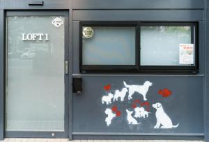 a door with cats and dogs painted on it at Flower Base Lily House in Fukuoka