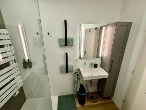 a bathroom with a sink and a mirror at Wolfgangsee Seeblickplatzl in Strobl