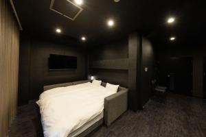 מיטה או מיטות בחדר ב-renu Beppu