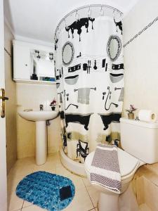 a bathroom with a black and white shower curtain at Hermanos in Flogita +36 photos