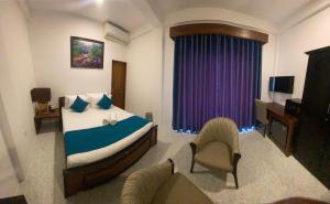 Ένα ή περισσότερα κρεβάτια σε δωμάτιο στο Trinco Beach Resort