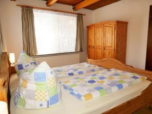 a bedroom with a large bed and a window at Lovely apartment in Apartment Lina in Pilsum