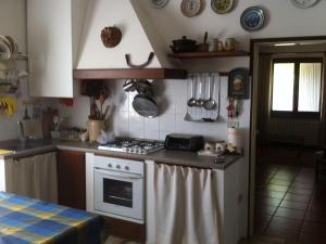 a kitchen with a stove top oven next to a window at Holiday Home near Lake Garda in Pastrengo