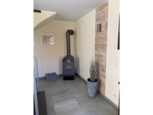 a hallway with a wood stove in a room at Just before the cape, holiday home B in Putgarten