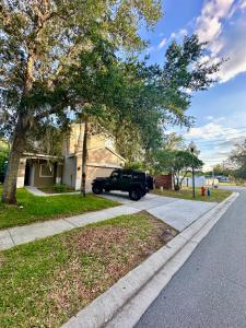 a truck parked in the driveway of a house at Panoramic 4BR Superior Pool Home near Disney Parks in Davenport