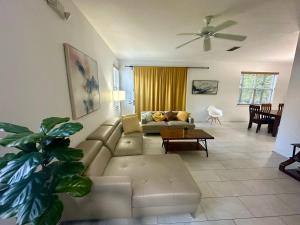 a living room with a couch and a table at Panoramic 4BR Superior Pool Home near Disney Parks in Davenport