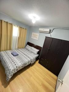 a small bedroom with a bed and a closet at One Oasis Condo 2 Bedroom Free Pool & Wifi Beside SM City Mall in Davao City