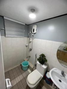 a bathroom with a toilet and a sink at One Oasis Condo 2 Bedroom Free Pool & Wifi Beside SM City Mall in Davao City