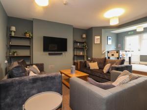 a living room with two couches and a flat screen tv at Eden Bay Retreat in Morecambe