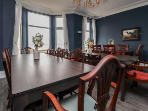 a dining room with a large table and chairs at Eden Bay Retreat in Morecambe