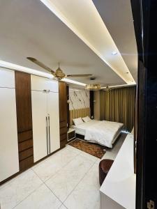 a bedroom with a bed and a ceiling fan at MG apartments in Jodhpur