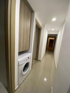 a laundry room with a washer and dryer in a building at Private Flat in Famagusta Center with Hotel Perks in Famagusta