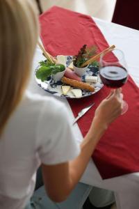 a woman sitting at a table with a plate of food at Private Flat in Famagusta Center with Hotel Perks in Famagusta +4 photos
