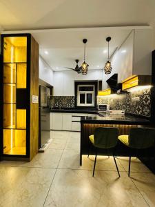 a kitchen with a table and some chairs in it at MG apartments in Jodhpur