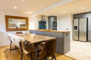 a kitchen and dining room with a wooden table and chairs at Linton Laithe in Skipton