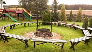 a park with benches and a playground with a fire pit at Galeria Pępowo in Żukowo