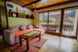 a living room with a couch and a table at Holiday Home Vila Kopriva in Gozd Martuljek