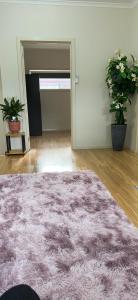 an empty room with a rug and two potted plants at One bedroom Apartment in Local shopping mall in Melbourne