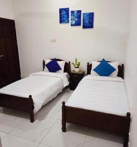 twee bedden naast elkaar in een kamer bij Meadows Living 2 BR Apartment near Mount Beach in Karagampitiya