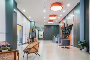 an office lobby with chairs and a desk at Go Hotels Plus Tuguegarao in Tuguegarao City